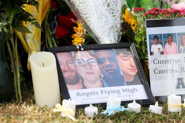 A memorial with images of those killed in last week's shooting rests outside Apalachee High School.