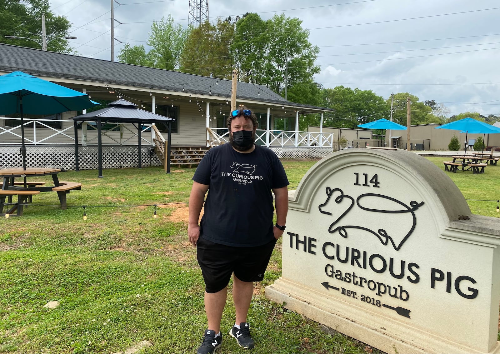 Scott Smith, chef-owner of the Curious Pig, stands on the expansive front lawn of his Peachtree City gastropub. Ligaya Figueras/ligaya.figueras@ajc.com