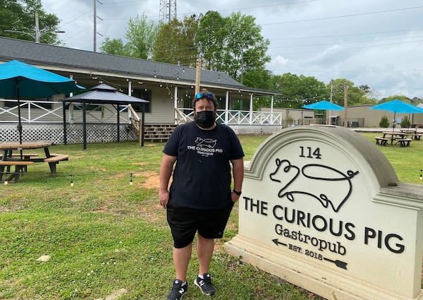 Scott Smith, chef-owner of the Curious Pig, stands on the expansive front lawn of his Peachtree City gastropub. Ligaya Figueras/ligaya.figueras@ajc.com