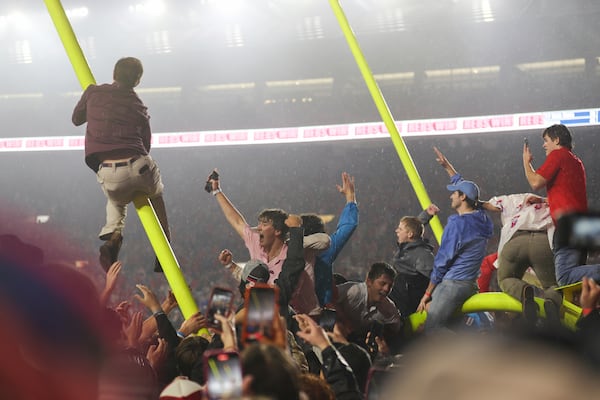 Mississippi fans brings down the goal post at the end of an NCAA college football game against Georgia on Saturday, Nov. 9, 2024, in Oxford, Miss. Mississippi won 28-10. (AP Photo/Randy J. Williams)