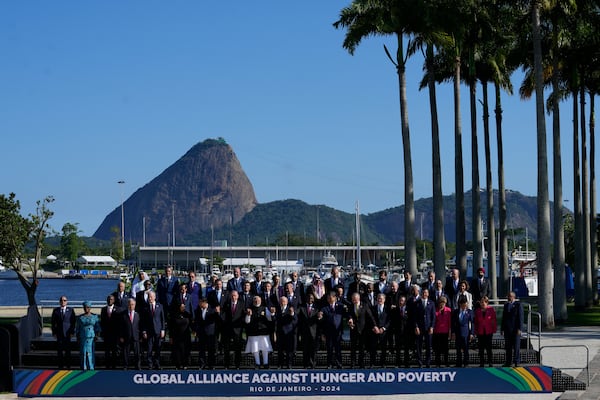 Backdropped by Sugar Loaf mountain, leaders attending the G20 Summit pose for a group photo in Rio de Janeiro, Monday, Nov. 18, 2024. (AP Photo/Eraldo Peres)