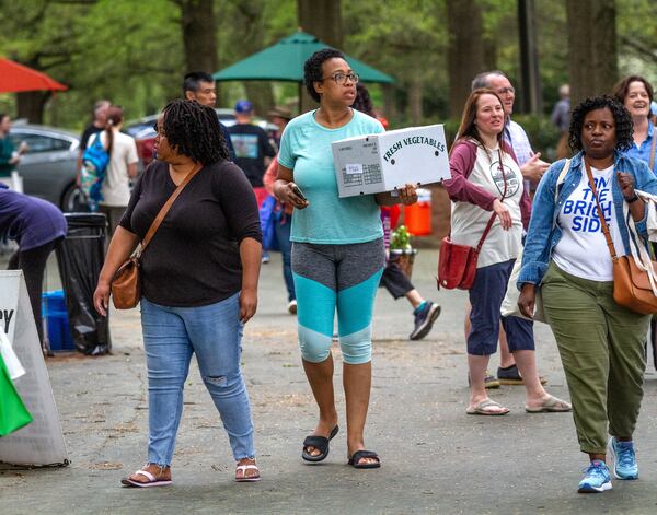 Stefani Taylor walks through the Carter Center Farmers Market Saturday, March 28, 2020.   STEVE SCHAEFER / SPECIAL TO THE AJC