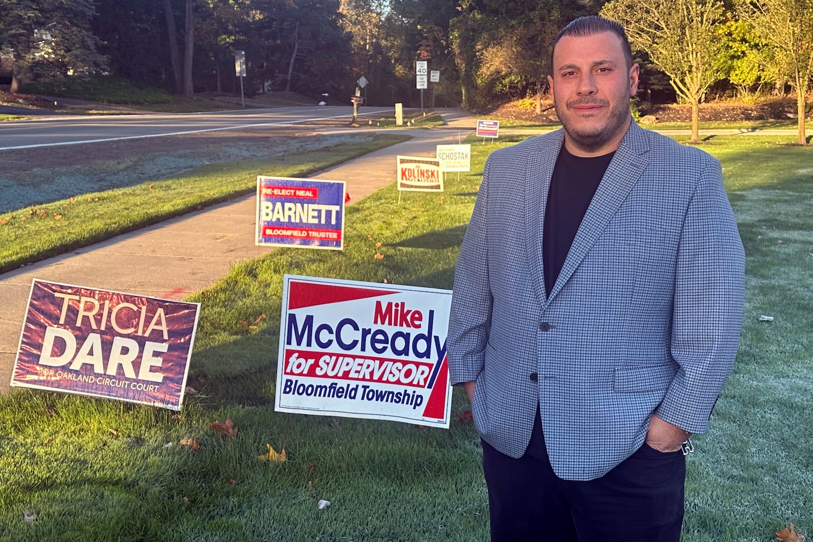 Nick Hannawa stands in his yard outside his home in Bloomfield Township, Mich., Thursday, Oct. 17, 2024. (AP Photo/Corey Williams)