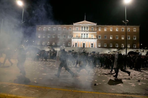 Riot police use tear gas against protesters during a rally, after the Greek opposition parties have challenged the country's center-right government with a censure motion in parliament over a devastating rail disaster nearly two years ago, in Athens, Wednesday, March 5, 2025. (AP Photo/Petros Giannakouris)