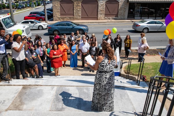 CHRIS 180’s Clinical Director Luz Soto Garcia, address the crowd along West Crogan Street in Lawrenceville to celebrate the therapy services expansion with a ribbon cutting and tours of the facility on Thursday, June 13, 2024.  The counseling services and trauma-informed care for children and families in Gwinnett County is now available in a new larger location allowing the office to grow from 5 to 15 therapists.  (Jenni Girtman for The Atlanta Journal-Constitution)  