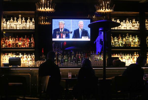 People watch a broadcast of the final debate between President Donald Trump and Democratic presidential nominee Joe Biden at The Abbey, with socially distanced outdoor seating, on Oct. 22, 2020, in West Hollywood, California. (Mario Tama/Getty Images/TNS)