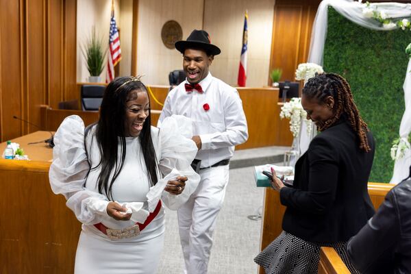 Newlyweds Lakiela and Antonio Fleetwood walk out of Courtroom 9G after taking their vows at the Fulton County Courthouse in Atlanta on Valentines Day, Tuesday, February 14, 2023. (Arvin Temkar / arvin.temkar@ajc.com)