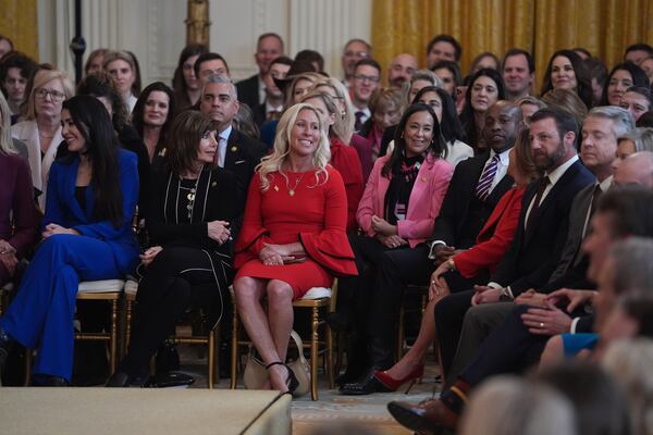 Georgia U.S. Rep. Marjorie Taylor Greene (center, in red), a Republican from Rome, was among those on hand when President Donald Trump spoke before before signing an executive order about transgender athletes on Wednesday.