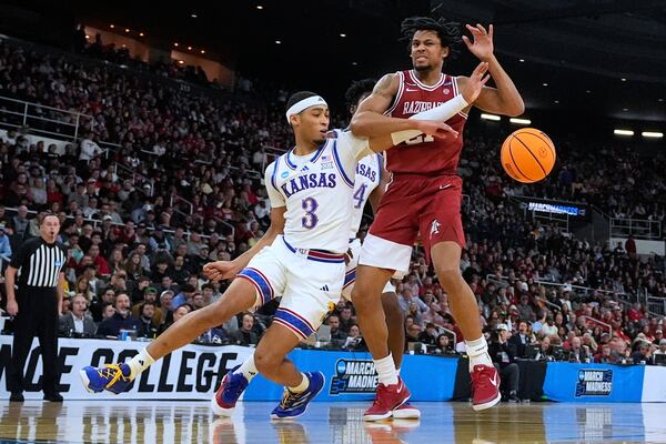 Kansas guard Dajuan Harris Jr. (3) strips the ball from the hands of Arkansas guard D.J. Wagner (21) during the first half in the first round of the NCAA college basketball tournament, Thursday, March 20, 2025, in Providence, R.I. (AP Photo/Charles Krupa)