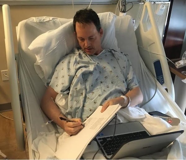 House Minority Leader Bob Trammell, D-Luthersville, puts his signature on HB 756 from his hospital bed, where he was being treated for a burst appendix. Photo by Fletcher Sams/Altamaja Riverkeeper