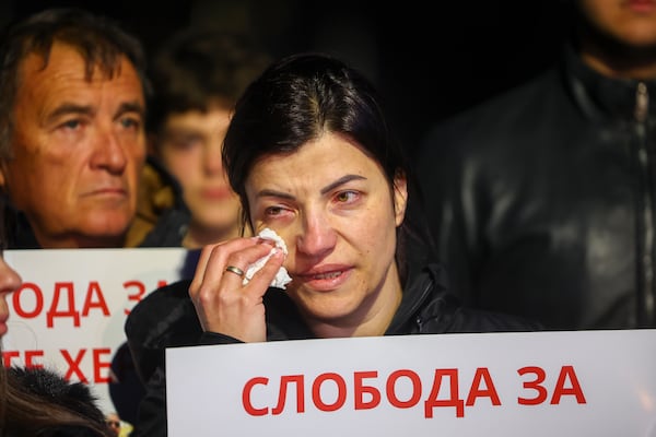 People hold posters of security personnel of a nightclub that was the scene of a massive fire, which read "Freedom for Our Heroes" in the town of Kocani, North Macedonia, Tuesday, March 18, 2025. (AP Photo/Armin Durgut)