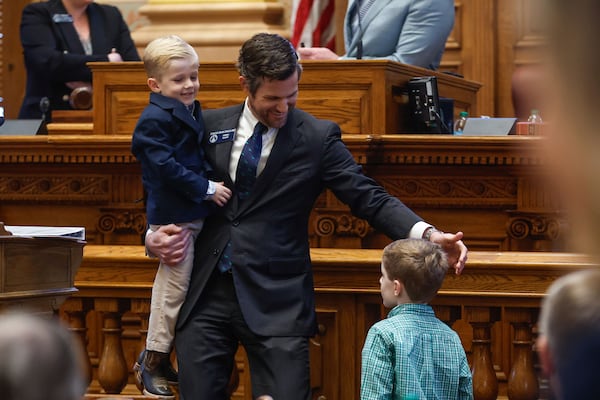 Sen. Brian Strickland, R-McDonough, shown with his sons Beecher (left), 5, and Charles Willis, 7, during the Georgia Legislative session on Feb. 19. (Natrice Miller/Atlanta Journal-Constitution)