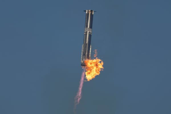 SpaceX's mega rocket Starship booster returns to the launch pad during a test flight from Starbase in Boca Chica, Texas, Thursday, Jan. 16, 2025. (AP Photo/Eric Gay)