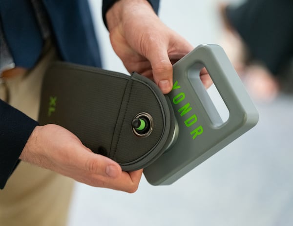 An employee demonstrates the cellphone locking bags to be used in Marietta City Schools.