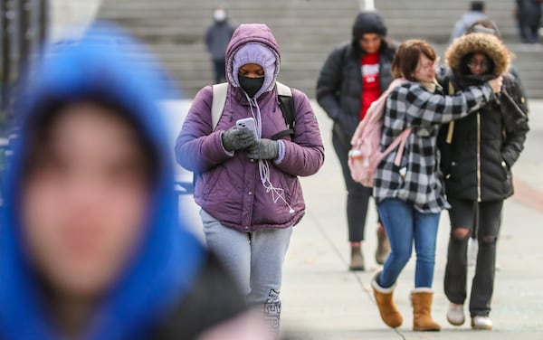 Students bundled up against the bitter cold on the Tech Walkway on the Georgia Tech campus on Tuesday morning, Jan. 16, 2024. Temperatures fell into the 20s and 30s as a cold front swept across the area on Tuesday morning. It’s winter’s first blast of dangerously cold arctic air, with temps running nearly 20 degrees below normal, according to the National Weather Service. In fact, it’s the coldest air we’ve seen in more than a year.  (John Spink / John.Spink@ajc.com)

