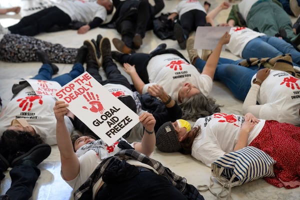 FILE - Demonstrators protest against cuts to American foreign aid spending, including USAID and the PEPFAR program to combat HIV/AIDS, at the Cannon House Office Building on Capitol Hill, Feb. 26, 2025, in Washington. (AP Photo/Mark Schiefelbein, file)