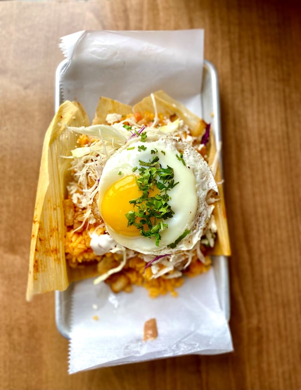 The tamale bowl at La Mixteca Tamale House is a one-of-a-kind creation that elevates a humble ball of masa dough into a multi-layered conveyor of comfort. Two tamales are showered with beans, rice, salsa, French fries, queso fresco, sour cream, cabbage, cilantro and an egg any way. 
(Wendell Brock for The Atlanta Journal-Constitution)