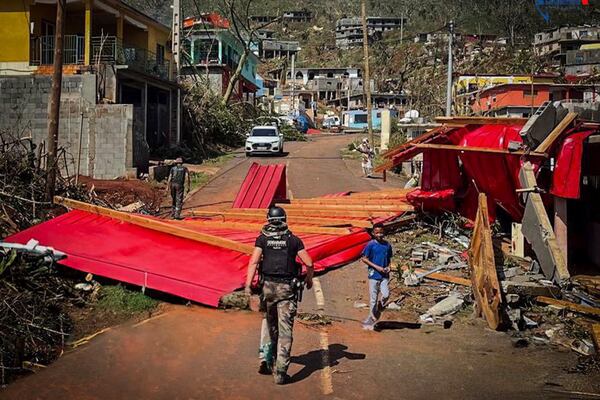 This photo provided on Monday Dec.16, 2024 by the Gendarmerie Nationale, shows a French Gendarme walking in among debris Sunday, Dec. 15, 2024 in Mayotte as France rushed rescue teams and supplies to its largely poor overseas department in the Indian Ocean that has suffered widespread destruction. (Gendarmerie Nationale via AP)