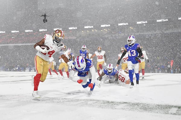 San Francisco 49ers running back Jordan Mason (24) runs against Buffalo Bills safety Damar Hamlin (3) during the second half of an NFL football game in Orchard Park, N.Y., Sunday, Dec. 1, 2024. (AP Photo/Adrian Kraus)