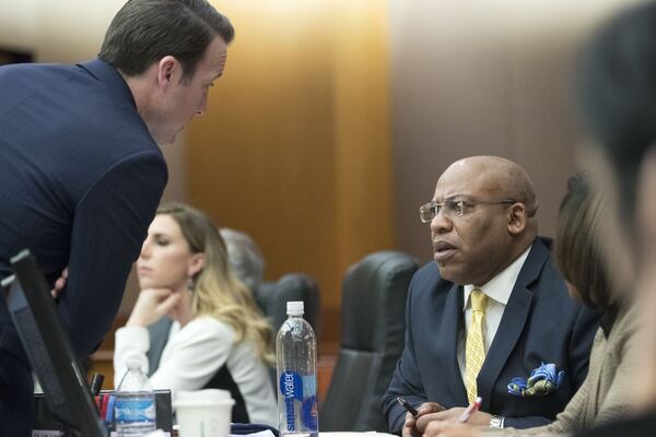 Fulton County Assistant District Attorney Adam Abatte, left, speaks with Fulton County Chief Assistant District Attorney Clint Rucker during the second day of the Tex McIver murder trial in Fulton County Superior Court in Atlanta on Wednesday, March 14, 2018. (ALYSSA POINTER/ALYSSA.POINTER@AJC.COM)