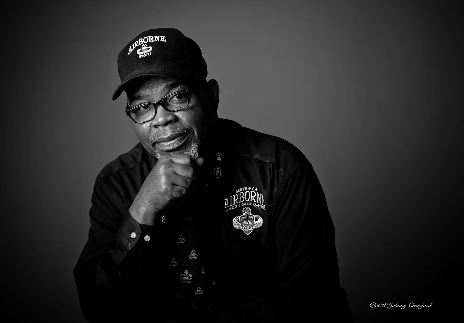 For his own portrait in the exhibit, Johnny Miller wore a hat carrying the emblem of the 555th Parachute Infantry Battalion. The Army’s first all-Black paratrooper unit, the 555th was trained for combat but deployed to put out any fires ignited by bomb-laden balloons Japan launched at North America during World War II. Miller leads the Atlanta chapter of an association honoring the groundbreaking unit, nicknamed the Triple Nickels. Photo by Johnny Crawford