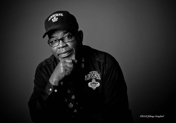 For his own portrait in the exhibit, Johnny Miller wore a hat carrying the emblem of the 555th Parachute Infantry Battalion. The Army’s first all-Black paratrooper unit, the 555th was trained for combat but deployed to put out any fires ignited by bomb-laden balloons Japan launched at North America during World War II. Miller leads the Atlanta chapter of an association honoring the groundbreaking unit, nicknamed the Triple Nickels. Photo by Johnny Crawford