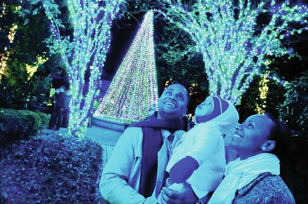 Sam Carter, left, and Tutu Carter, far right, with their daughter Rachel Carter, enjoy the Garden Lights at the Atlanta Botanical Garden. Photo: Joey Ivansco