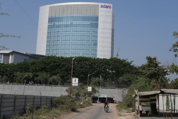 A motorcyclist ride past the Adani's corporate house in Ahmedabad, India, Thursday, Nov. 21, 2024. (AP Photo/Ajit Solanki)