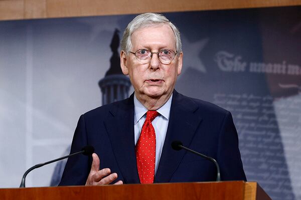 Senate Majority Leader Mitch McConnell of Ky., speaks with reporters after the Senate approved a nearly $500 billion coronavirus aid bill on Capitol Hill in Washington.