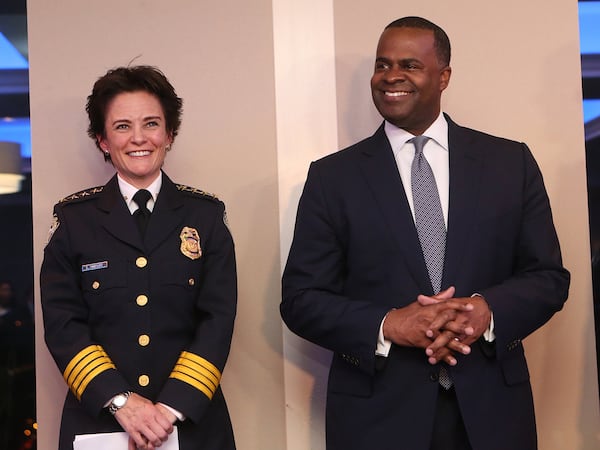 Atlanta Chief of Police Erika Shields shares a laugh with Mayor Kasim Reed during her oath of office ceremony last year. In a statement, Shields said it was a “reasonable assist” for members of her department’s Executive Protection Unit to pick up the mayor’s meals and dry cleaning. She did not respond to a question about the appropriatness of the officers using city-issued credit cards to do so. CURTIS COMPTON/CCOMPTON@AJC.COM