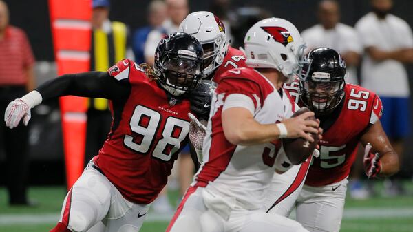 Atlanta Falcons defensive ends Takkarist McKinley (98) and Jack Crawford (95) pressure the Cardinals quarterback Drew Stanton.