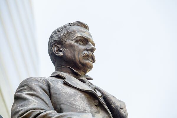 The statue of Samuel Spencer stands in front of the Norfolk Southern building on Peachtree Street on Tuesday, April 13, 2021.  The city owns the statue and Norfolk Southern is asking permission to store the confederate monument of their first president, until they decide what to do with it.  (Jenni Girtman for The Atlanta Journal-Constitution)