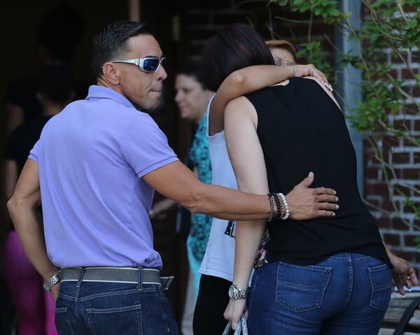 Loved ones gathered at a community center where authorities are providing information and support. AJC photo: Curtis Compton