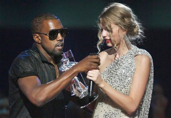 Kanye West takes the microphone from Taylor Swift as she accepts the "Best Female Video" award during the MTV Video Music Awards in New York on Sept 13, 2009. (AP Photo/Jason DeCrow, File)