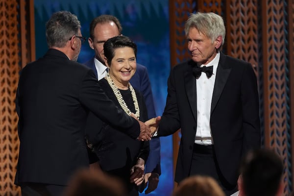 Harrison Ford, far right, presents the award for outstanding performance by a cast in a motion picture to Sergio Castellitto, far left, and Isabella Rossellini during the 31st annual Screen Actors Guild Awards on Sunday, Feb. 23, 2025, at the Shrine Auditorium in Los Angeles. (AP Photo/Chris Pizzello)