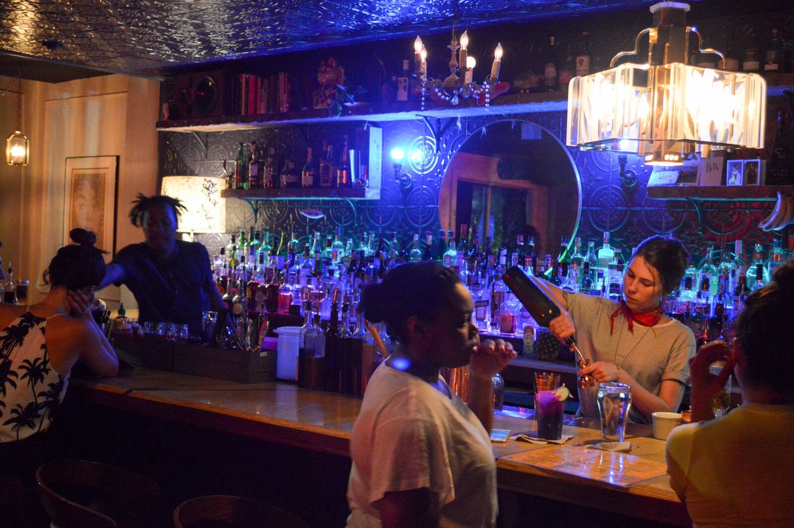 At Bon Ton, blue lights over the bar contrast with the red neon of the “Fancy Service” sign, adding to the restaurant’s late-night bar ambience. CONTRIBUTED BY HENRI HOLLIS