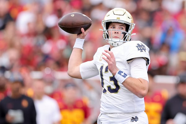 Notre Dame quarterback Riley Leonard throws during the first half of an NCAA football game against Southern California, Saturday, Nov. 30, 2024, in Los Angeles. (AP Photo/Ryan Sun)