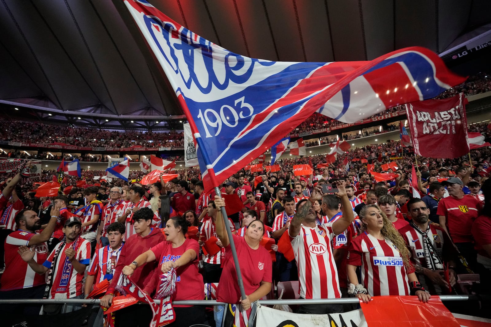 Atletico fans cheer before the La Liga soccer match between Atletico Madrid and Real Madrid at the Metropolitano stadium in Madrid, Spain, Sunday, Sept. 29, 2024. (AP Photo/Bernat Armangue)