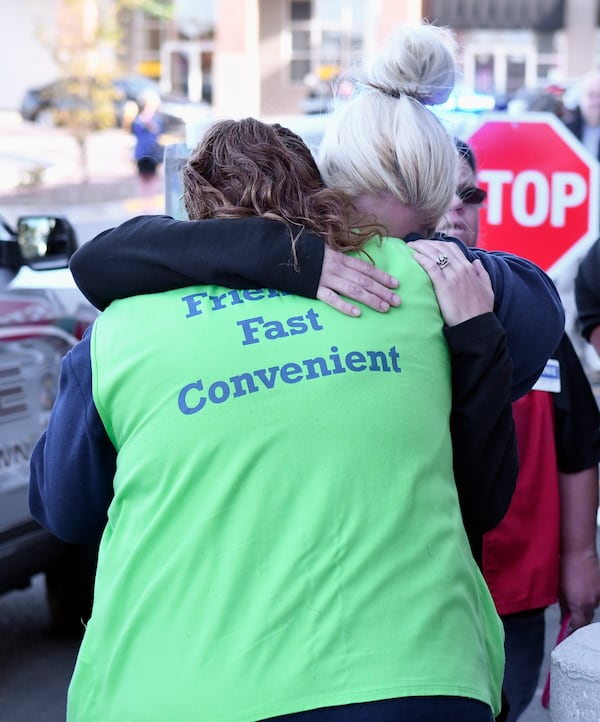 Kroger employees hug each other in the aftermath of shooting that left two people dead and a suspect, Gregory Bush, in custody in Jeffersontown, Ky. 