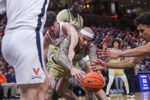 Virginia's Blake Buchanan, upper center, and Georgia Tech's Duncan Powell, center, fight for the ball during an NCAA college basketball game between Georgia Tech and Viriginia, Saturday, Feb. 8, 2025, at John Paul Jones Arena in Charlottesville, Va. (Cal Cary/The Daily Progress via AP)