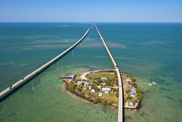 In the Keys, Henry Flagler’s original Seven Mile Bridge bisects Pigeon Key on the right, while today’s modern-day bridge is on the left. ANDY NEWMAN / FLORIDA KEYS NEWS BUREAU