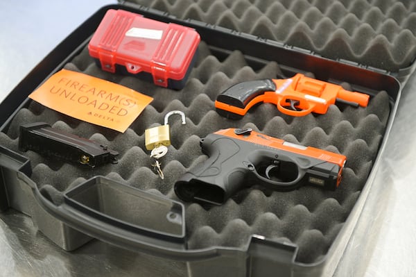 A hard-sided case, locks, handguns, and firearms declaration cards are seen Wednesday, March 6, 2022 at Hartsfield-Jackson International Airport. These items are needed to properly transport firearms on flights.  (Daniel Varnado/For the Atlanta Journal-Constitution)