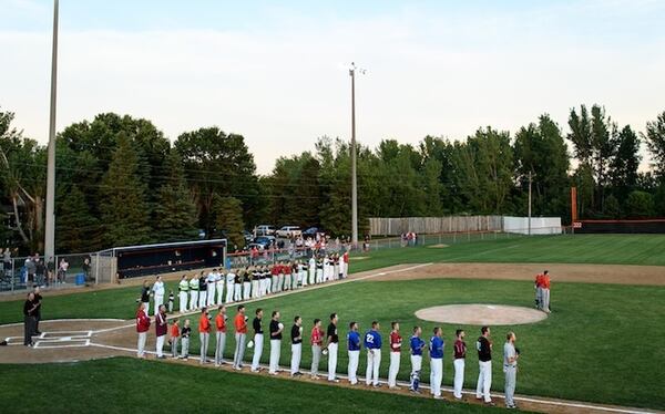 Players from the County Line League, back, and the Stearns County League held their hats over their hearts for the national anthem before their all-star game on Friday, June 30, 2017 in Elrosa, Minn. (Aaron Lavinsky/Minneapolis Star Tribune/TNS)