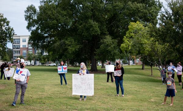 Parents and teachers protest the City Schools of Decatur plan to reopen in-person learning by gathering in front of the school’s headquarters in downtown Decatur on Tuesday, Sept. 22, 2020. Ben Gray for the Atlanta Journal-Constitution