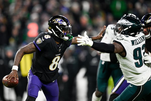 Baltimore Ravens quarterback Lamar Jackson (8) is pressured by Philadelphia Eagles defensive tackle Milton Williams (93) during the second half of an NFL football game, Sunday, Dec. 1, 2024, in Baltimore. (AP Photo/Nick Wass)