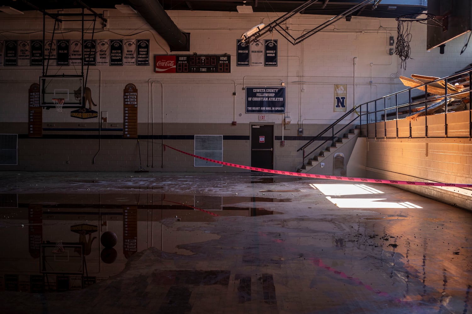 The old gymnasium at Newnan High School also suffered damage to its ceiling and water on its court. (Alyssa Pointer / Alyssa.Pointer@ajc.com)