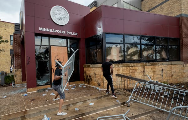 Protesters damage property at the Minneapolis 3rd Police Precinct.