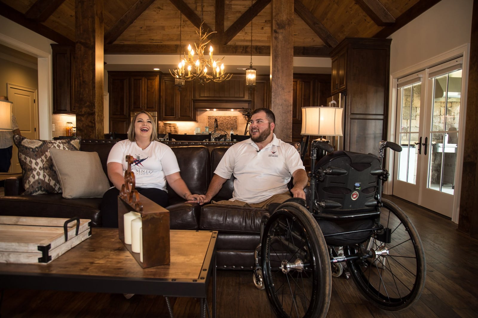 Retired Cpl. Sean Adams and his girlfriend Callie Baize sit in the living room of their new specially adapted smart home in Maysville on May 19, 2017. The house was built and donated to Adams, who was wounded in the war in Afghanistan, through the Gary Sinise Foundation. STEVE SCHAEFER / SPECIAL TO THE AJC