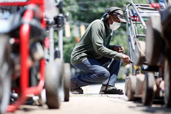 Small Engine Repair owner Joseph Allen works in a lawn mower at his shop on Memorial Drive at 97 degrees on Wednesday, June 22, 2022. "I have to drink a gallon of water every day to be able to do my work outside with this weather," Allen said. Miguel Martinez / Miguel.martinezjimenez@ajc.com