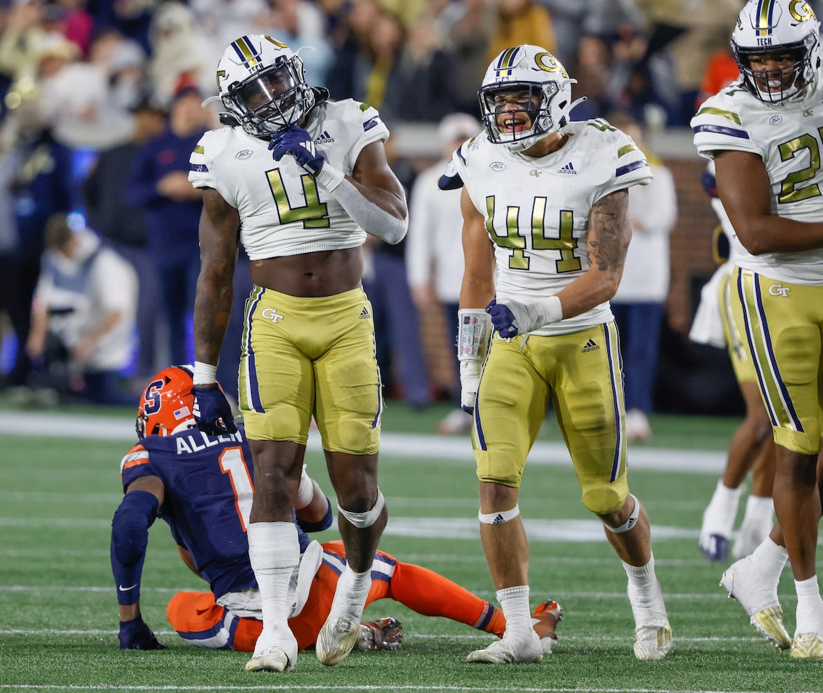 Georgia Tech Yellow Jackets linebacker Braelen Oliver (4) and defensive back Jaylon King (14) celebrate after stopping Syracuse Orange running back LeQuint Allen (1) for no gain during the second half of an NCAA college football game between Georgia Tech and Syracuse in Atlanta on Saturday, Nov. 18, 2023.  Georgia Tech won, 31 - 22. (Bob Andres for the Atlanta Journal Constitution)